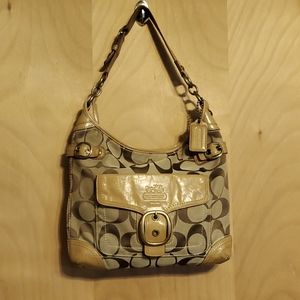 COACH tan and brown shoulder bag. Leather trimmed.